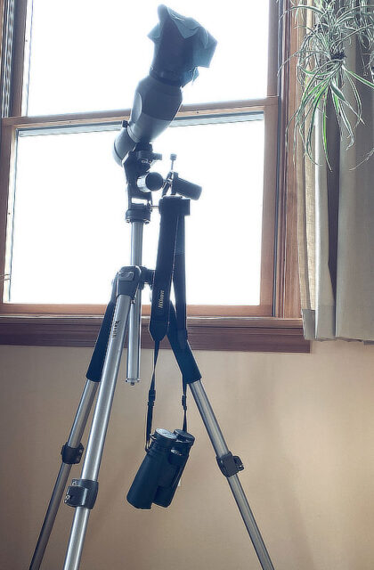 Binoculars and spotting scope by the window.