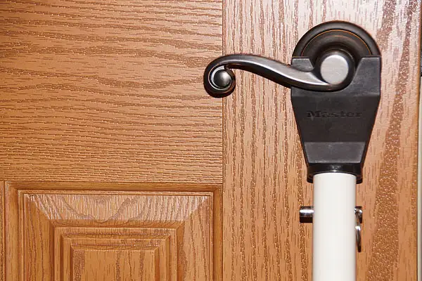 Door security bar is designed to tuck under the doorknob
