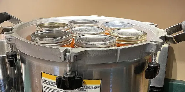 pressure canner filled with quart jars of carrots