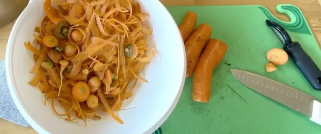 peeling and slicing carrots before canning