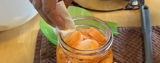wiping the rim of canning jar